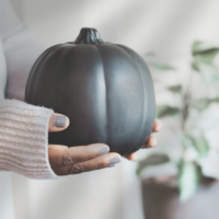 Fern the Geek holding a black pumpkin for fall decor, this geek life blog